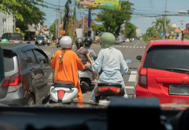 Friends riding motorcycles down a road