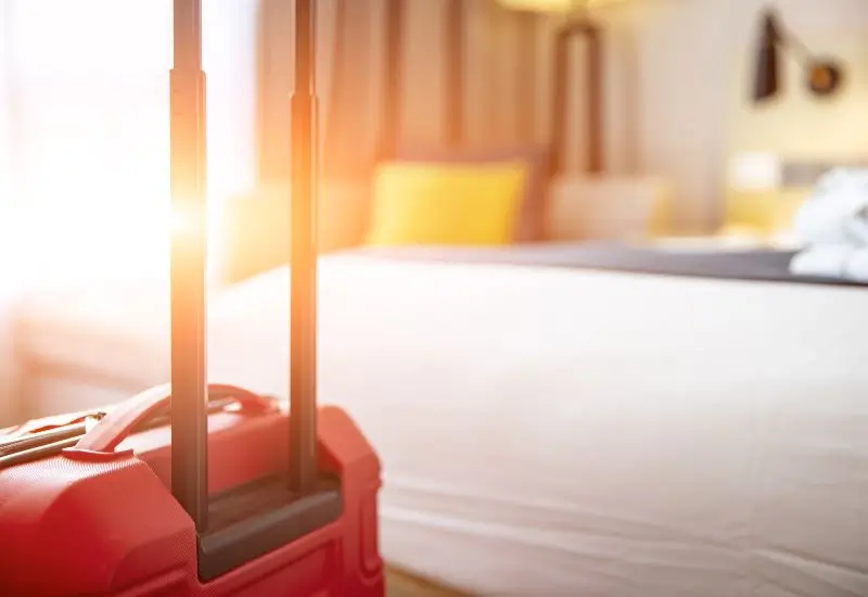 Interior of hotel room with red suitcase