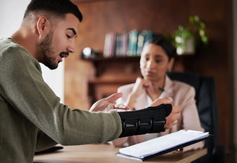 Man with personal injury discussing documents with lawyer