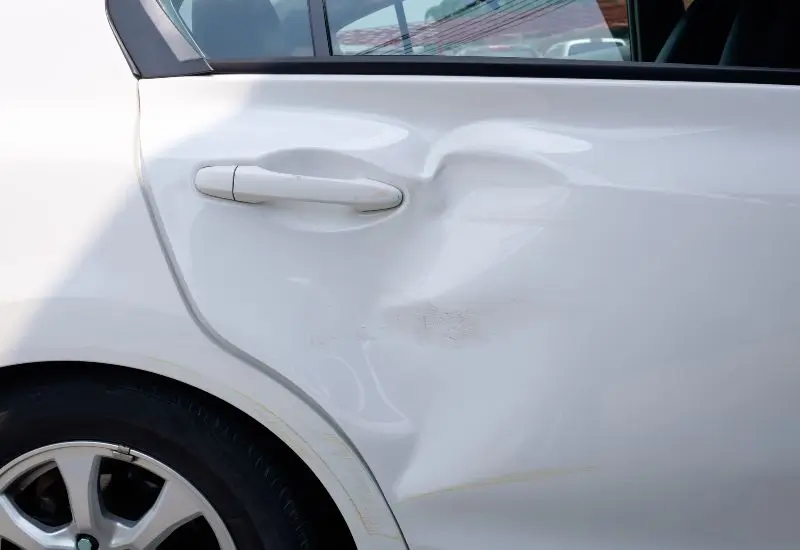 Rear door of white car that got T-bone damage