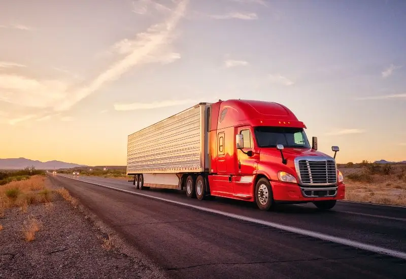 Red long haul semi-truck on the road